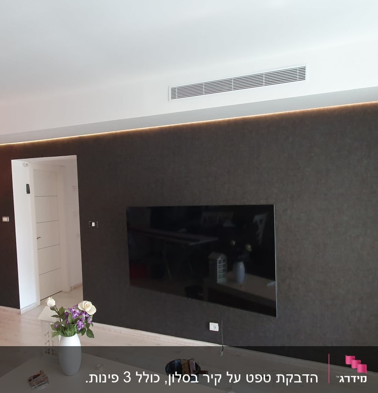 קיר עם טפט כהה וטלוויזיה תלויה